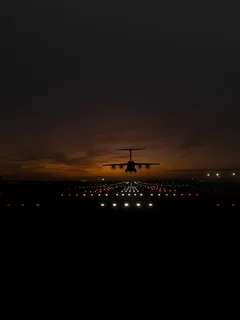Großes Jetflugzeug fliegt nachts über Startbahn